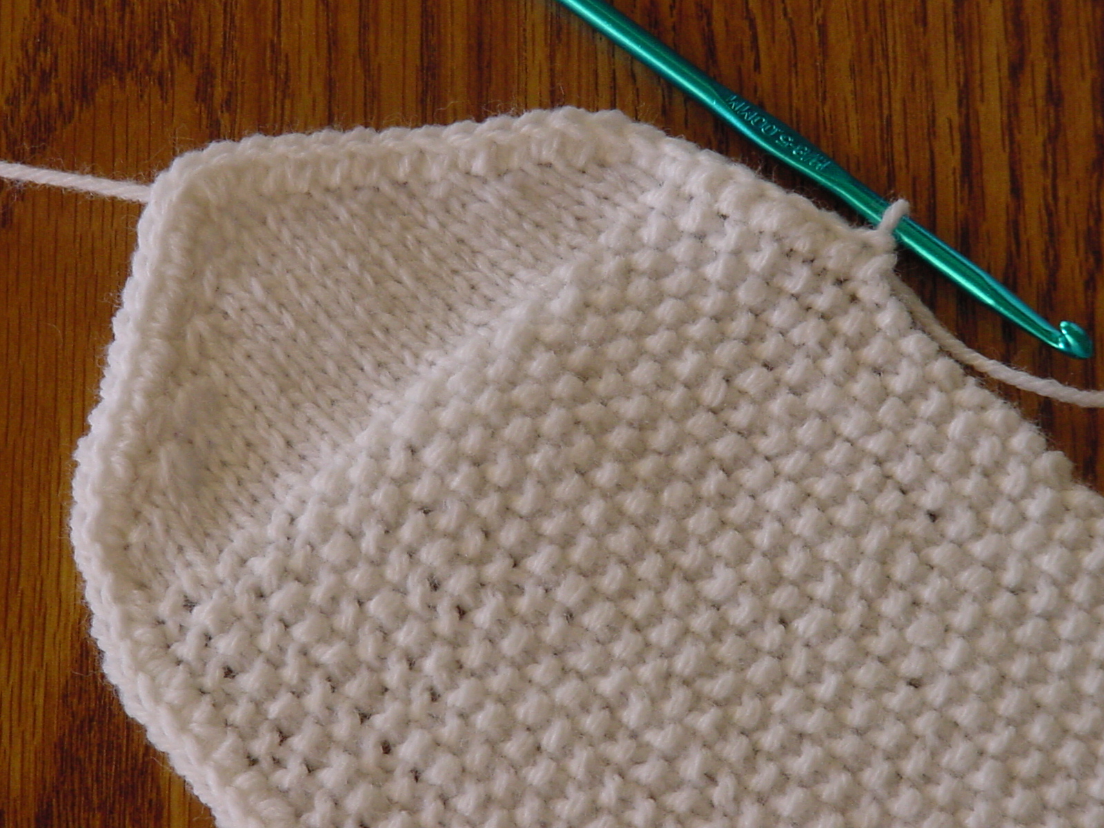 Crocheting around the edge of the knitted gift pouch